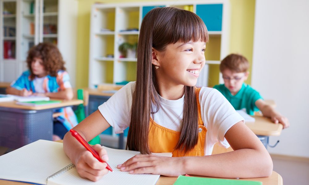 Happy Girl Student at Desk